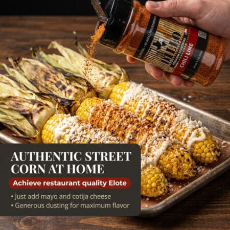 A hand shaking a bottle of Dillo Chili Lime seasoning over a tray of roasted corn on the cob that has been topped with mayonnaise and cotija cheese. The text overlay reads, "Authentic Street Corn At Home. Achieve restaurant quality Elote. Just add mayo and cotija cheese. Generous dusting for maximum flavor."
